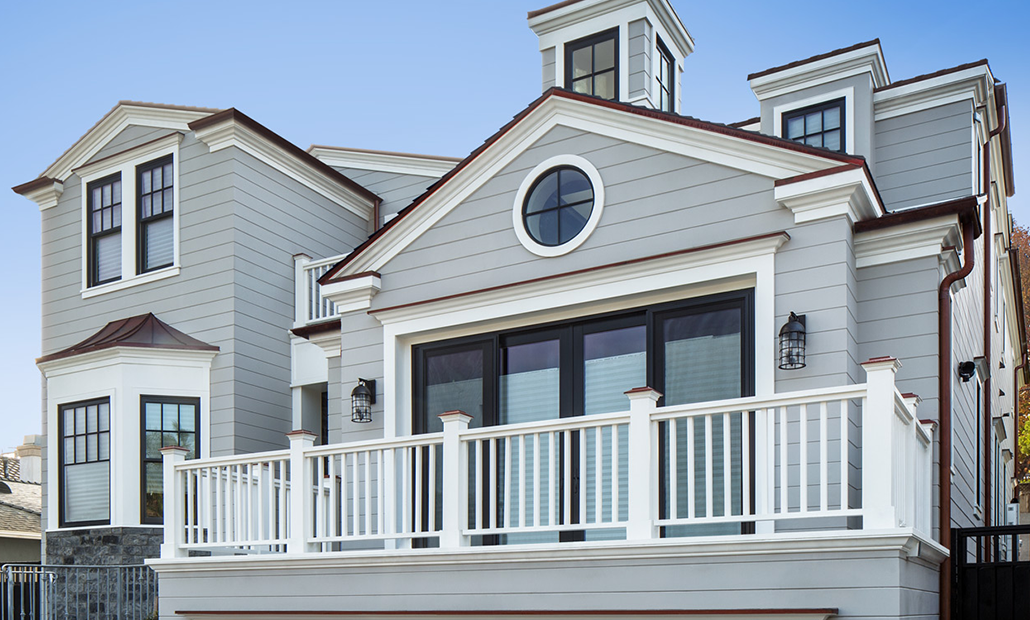 A background image featuring a beautiful home with grey siding