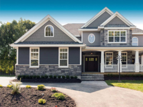 Grey Gentek Aluminum horizontal siding that abuts a bottom accent siding of stone