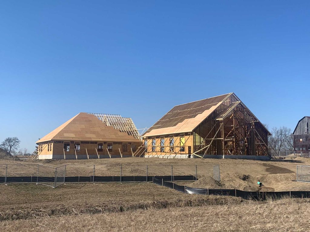 An image of a frame of a house with trusses exposed