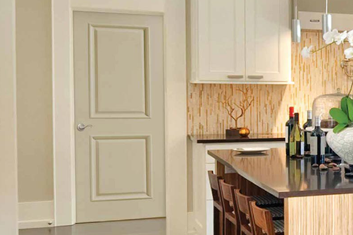 An interior door adjoining a beautiful kitchen from Turkstra Trim and Doors