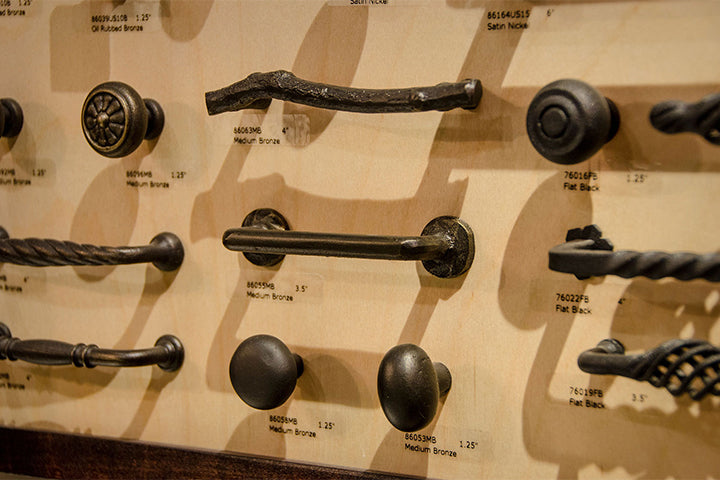 Multiple styles of cabinet hardware in a bronze finish