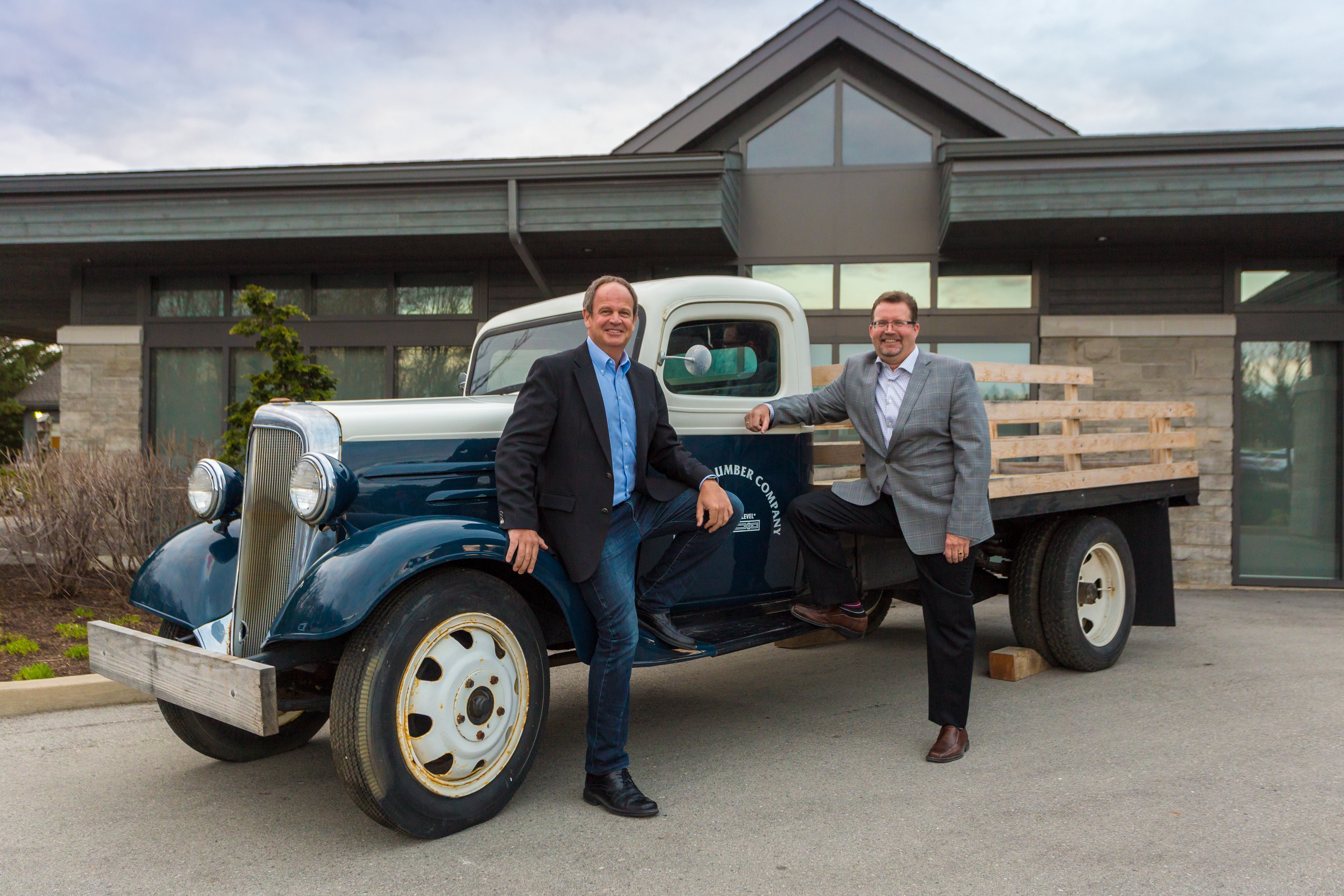 Our owner, Peter Turkstra, and a Turkstra Lumber executive posing with our preserved retro delivery truck