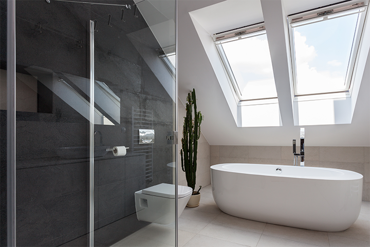 Velux manual venting skylights installed above a half-storey bathtub in a modern bathroom