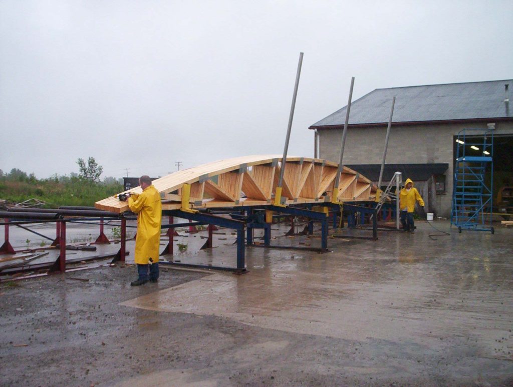 An image of trusses being prepared to be loaded on a truck for delivery