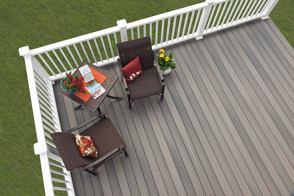 A bird's eye view of a grey composite deck with white pvc railings