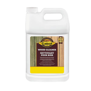 Image shows a 3.78L plastic container of Cabot Wood Cleaner. The label states it removes dirt, mold, and mildew, and prepares wood surfaces for staining. Features a visual comparison of wood before and after cleaning.