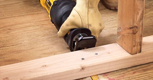A contractor using a Dewalt 20V reciprocating saw on framing.