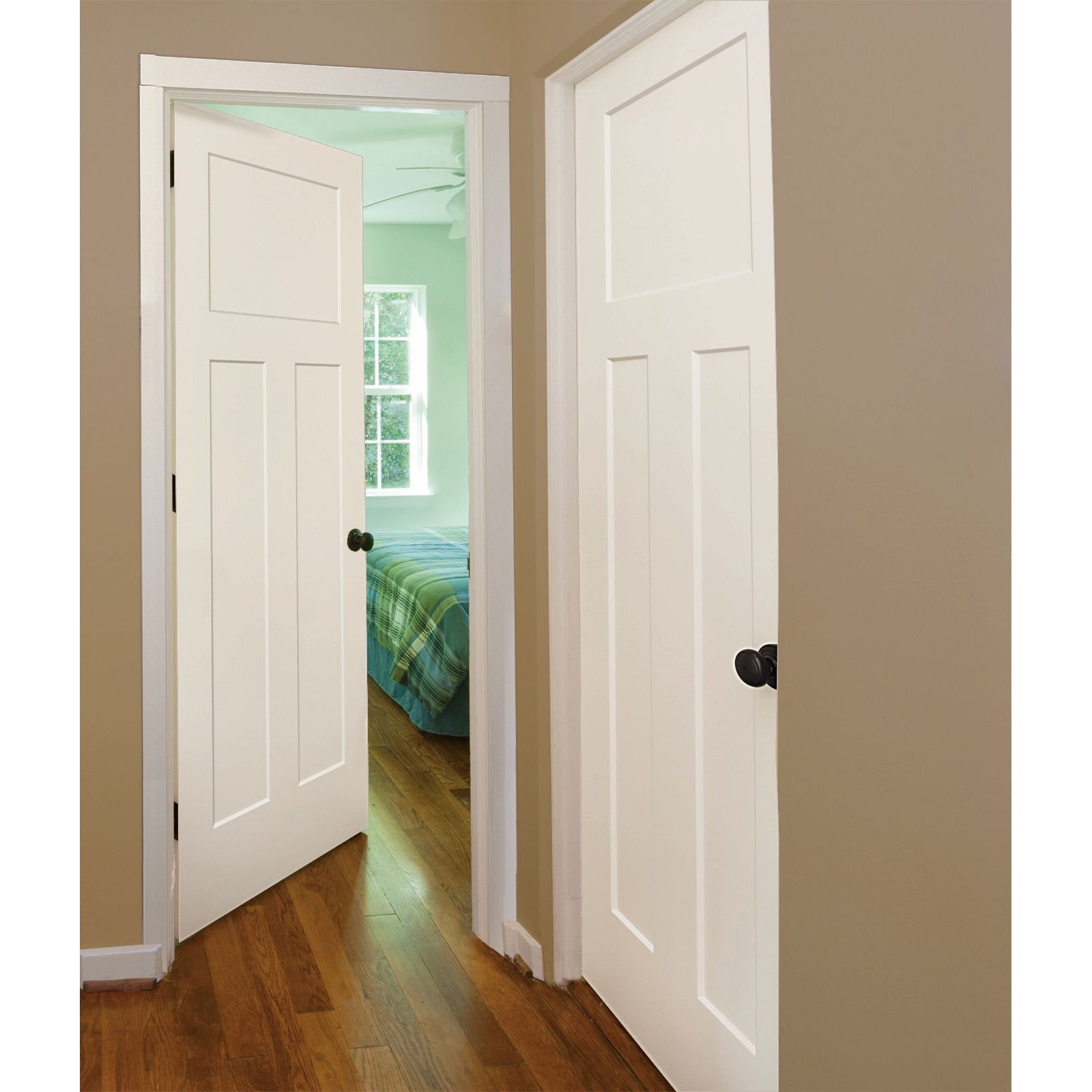 A hallway features two Jeld-Wen 12"x80"x1-3/8" Craftsman 3-Panel Recessed Slab doors—one open to a bedroom with a green and blue plaid bedspread, wooden floors, beige walls, and daylight streaming through a window.