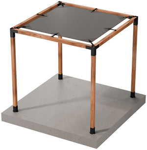 A square wooden pergola frame with four posts stands on a concrete slab, featuring a Sage Sunshade 8x8 in Gray from Simpson Strong-Tie® attached to the top for added UV protection.