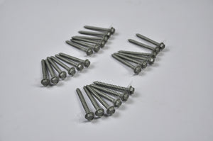 Four groups of Regal Rail 2-1/2" Lag Screws, Titanium Slate (24 pieces), are arranged on a white surface in a symmetric pattern—ideal for aluminum railing systems or mounting rail components.