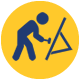 Icon of a person using a hammer on a surface supported by a sawhorse, depicted in blue on a yellow circular background, symbolizing construction or carpentry work.