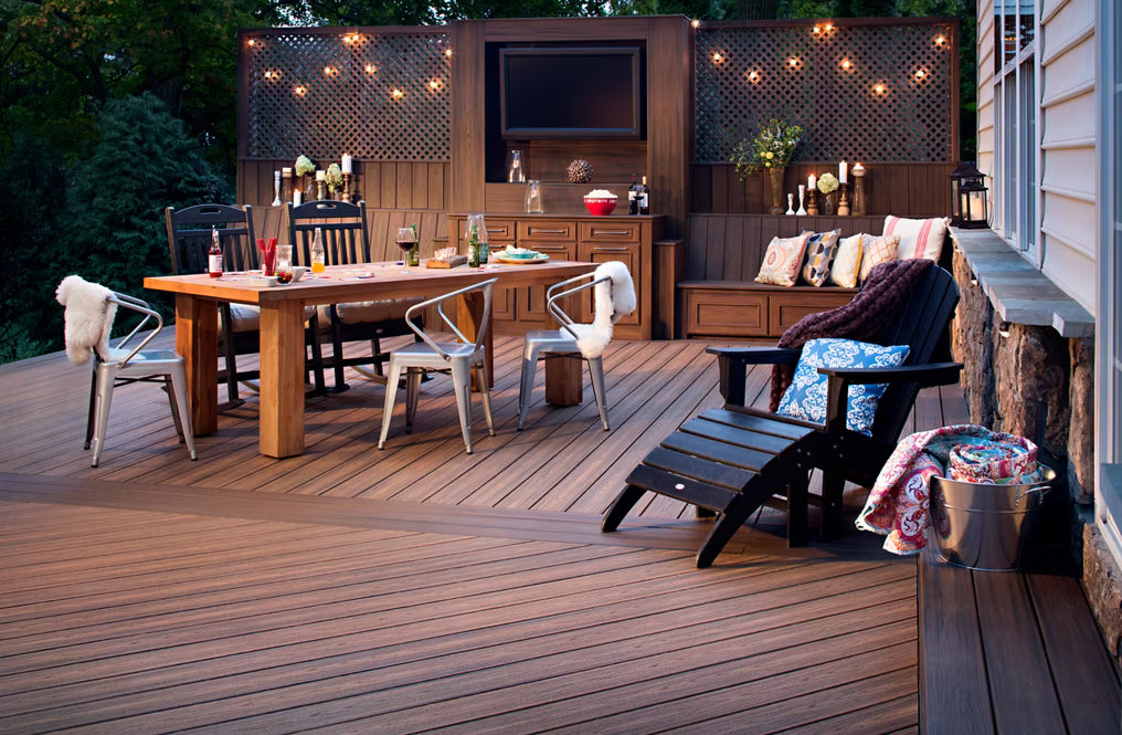 A brown composite Trex deck featuring a cozy lounge chair and dining set.