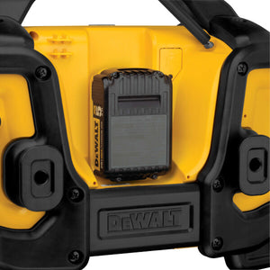 DeWalt radio charging a DeWalt battery pack on a white background