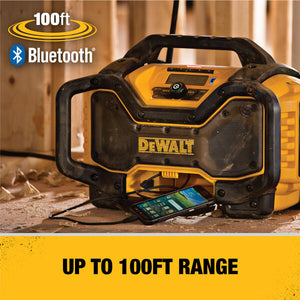 DeWALT Bluetooth radio on a wooden surface with a smartphone connected, featuring '100ft Bluetooth' text.