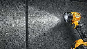 DeWalt cordless flashlight illuminating a dark surface
