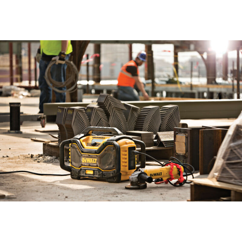 DeWalt radio charging a tool on a construction site with workers in the background